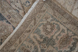 Vintage distressed Sparta carpet corner, showing worn texture, soft patterns, and fringe.