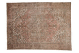 Decorative distressed vintage Mehrivan carpet with geometric concentric medallion, pink, beige, and seafoam motifs.