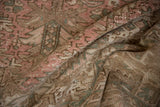 Distressed vintage Mehrivan carpet pile, showing dusty blush, beige, and sea foam green tones.