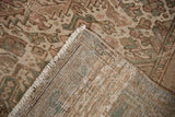 Vintage distressed Mehrivan carpet showing faded geometric pile, hand-knotted foundation, and fringe.