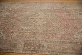 Distressed vintage Mehrivan carpet's textured geometric patterns and samovar border.