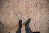 Distressed Sivas rug detail: dusty rose and dark aubergine multi-medallion with even wear.