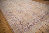 Distressed Sivas carpet with dusty rose and dark mauve arabesque border.