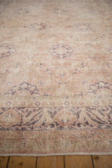 Distressed vintage Sivas carpet, delicate arabesque border in dusty rose and cream.