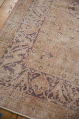 Distressed vintage Sivas rug: dusty rose, mauve arabesque, worn pile texture, intact selvage.