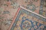 Distressed vintage Sparta rug with worn dusty rose abrashed field and blue, gold border.