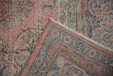 Distressed vintage Sparta carpet corner, revealing worn pile, woven foundation, and patterned border.