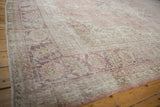 Distressed vintage Sparta carpet texture showing faded dusty rose, ivory, and mauve tones.