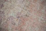 Distressed Sparta carpet close-up, dusty blush, ivory, pale violet floral vinery.