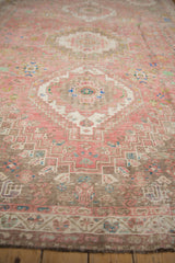 Distressed pink and beige Persian Abadeh pattern with sapphire blue accents and pile wear.