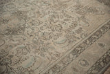 Distressed vintage Tabriz carpet with delicate floral blossoms, thin vinery, pale ivory, and coffee brown.