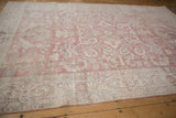 Distressed Sparta carpet border with faded rose and ivory scrolling floral vinery.