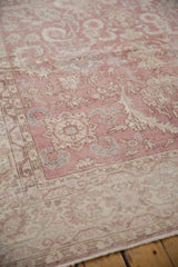 Detail of vintage distressed Sparta carpet with faded dusty rose, ivory scrolling vinery.