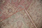 Distressed vintage Sparta rug's worn rose pile, ivory motifs, selvage, and visible foundation.