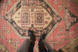 Distressed vintage Oushak rug with geometric vinery, serrated details in dusty pink, charcoal, ivory.