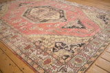 Distressed Oushak carpet with dusty pink field, geometric vinery, and serrated charcoal outlines.