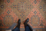 Geometric vintage Caucasian Soumac rug: octagonal medallion, starburst florals in madder red, indigo.