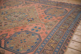 Madder red field, indigo blue starbursts, and chevron borders on this vintage Caucasian Soumac carpet.
