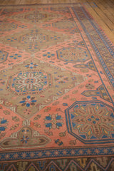 Madder red field with geometric starburst and floral pinwheel, chevron border with germinating plants.