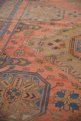 Detailed hand woven Soumac pattern of madder red, indigo, and beige starburst floral motifs.