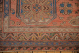Intricate chevron, crab, and wave pattern borders on a Vintage Caucasian Soumac carpet.