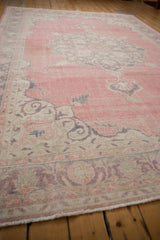 Faded bubblegum pink field and oxidized silver corner spandrel of vintage Sparta carpet.