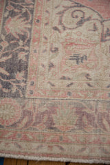 Distressed Sparta carpet border detail: faded mauve and oxidized silver motifs, low pile, and fringe.