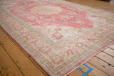 Distressed vintage Sparta carpet border with faded raspberry pink floral motifs.