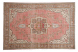 Distressed vintage Sparta carpet, faded raspberry red abrashed field with floral medallion.