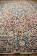 Distressed vintage Sparta carpet with soft melon and denim blue floral vinery.