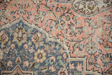 Distressed vintage Sparta carpet, worn floral vinery pattern, with faint foundation showing.