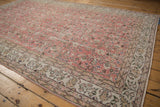 Distressed texture of dusty red rose field and ivory vine leaf border.