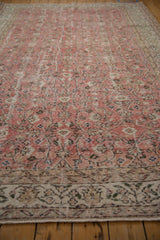 Distressed Sparta carpet pile with dusty red rose, worn scrolling vinery, and intricate border.