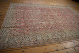Vintage Distressed Sparta carpet with abrash on dusty rose field and ivory scrolling vine border.