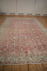 Distressed Sparta carpet border with dusty red rose field, ivory vine, and visible foundation wear.