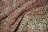 Worn pile of vintage Turkish Sparta rug, dusty red rose, ivory scrolling vinery.