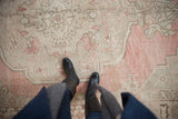 Evenly worn low pile texture of a vintage Oushak in dusty blush and ivory.