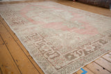 Angled view along the vintage Oushak carpet, highlighting its detailed Samovar main border.