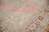Detail of the meandering Samovar border against the dusty blush and beige field of a vintage Oushak carpet.