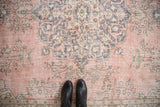 Distressed vintage Turkish Sparta carpet with time-softened pink, blue, ivory floral patterns.
