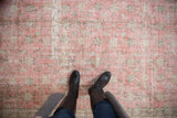 Blush pink distressed Sparta rug showing wear to foundation and floral vinery.