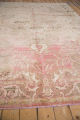 Distressed vintage Oushak rug's abrashed dusty blush and silver field with paisley boteh.
