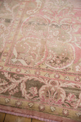 Distressed vintage Oushak rug detail: abrash, dusty blush, beige floral border pattern.
