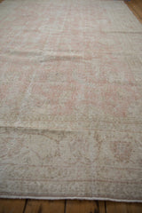 The low pile and ribbed texture of a distressed vintage Sparta carpet in faded pink.