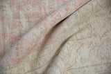 Distressed Sparta carpet with mostly even wear, showing the foundation between dusty rose knots.