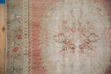 Distressed vintage Oushak runner's seafoam border and faded blush Rococo floral field.