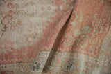 Distressed vintage Oushak runner's pliable texture, with blush and seafoam floral motifs.