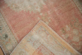 Vintage Distressed Oushak rug with softened blush pile and visible hand-knotted back.