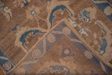 Detail of distressed Oushak rug corner, showing blue border and worn pile to foundation.