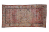 Decorative distressed Oushak rug, roundel medallion, Rococo floral relief, blush, sand, and gray.